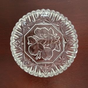 Vintage small cut glass plate with pressed fruit design on the bottom